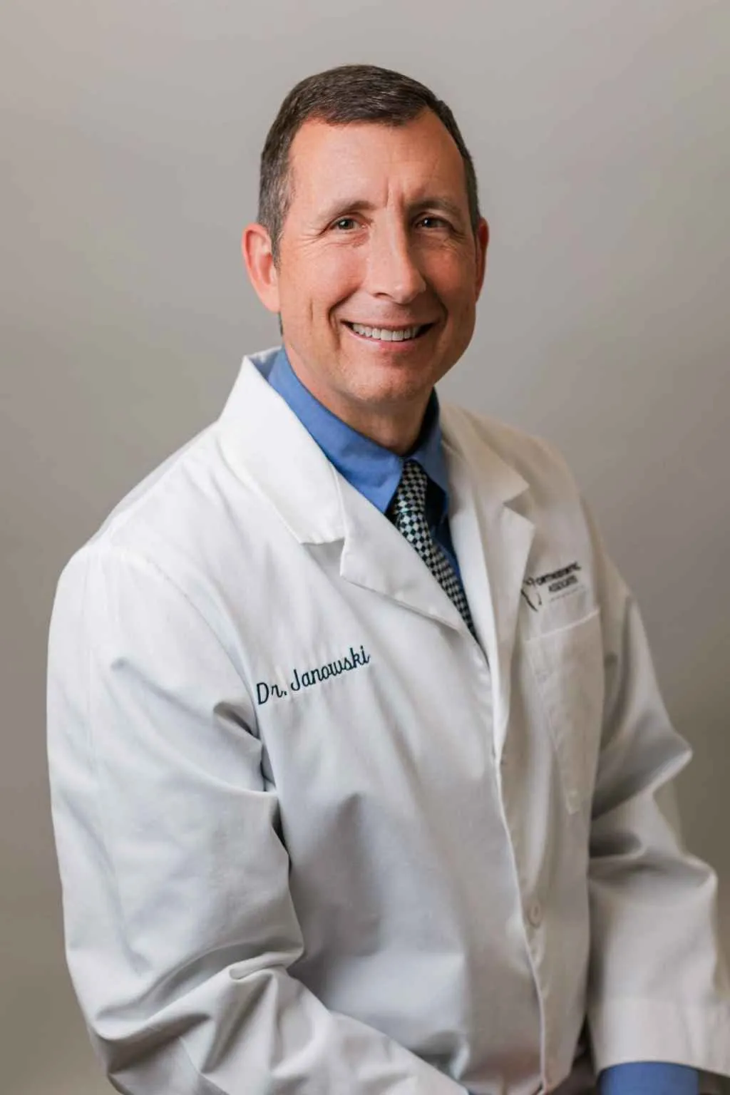 Dr. Joseph Janowski, board-certified orthodontist at Orthodontic Associates, smiling in professional attire.