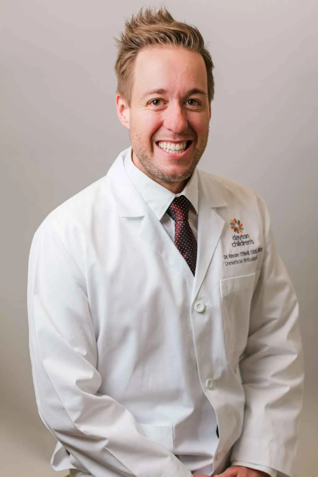 Dr. Kevan O’Neill, orthodontist and Lima native, in professional coat and tie.